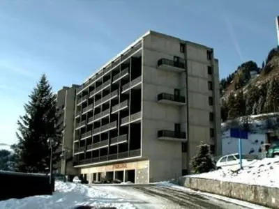 a building on a snowy street in front of a building at Studio Coin Montagne 25m² à Flaine, balcon et proximité pistes - FR-1-687-42 in Arâches-la-Frasse