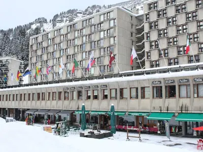 a building with a bunch of flags on top of it at Appartement 3 pièces, 8 pers, Résidence Cassiopée, Flaine Forum, à 50m des pistes et commerces - FR-1-687-87 in Arâches-la-Frasse