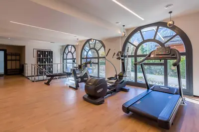 a gym with several treadmills and elliptical machines at Modern 2BR 5* pool gym spa garage Mont-Blanc view in Chamonix-Mont-Blanc