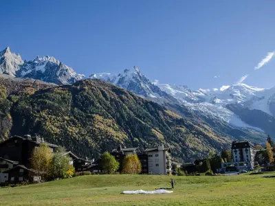 a mountain range with a town and buildings in a field at Studio au pied des pistes à Chamonix avec parking privé, proche centre - FR-1-343-162 in Chamonix-Mont-Blanc