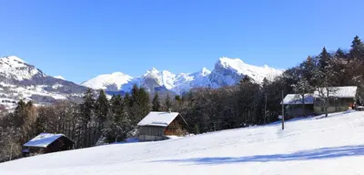 a snow covered mountain with houses on a snow covered slope at Grand Morillon - 104 - Montagne Belle Vue Studio 4 in Morillon