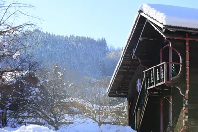 a snow covered cabin with a balcony in the snow at Grand Morillon - 104 - Montagne Belle Vue Studio 4 in Morillon