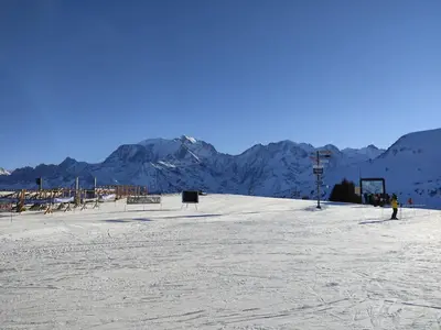 a snow covered slope with mountains in the background at Holiday Home L'Adret by Interhome in Saint-Gervais-les-Bains