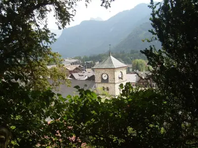 an old building with a clock tower in a town at Appartement 3 pièces, 6 pers., Samoëns, avec Wifi et Parking - FR-1-629-11 in Samoëns