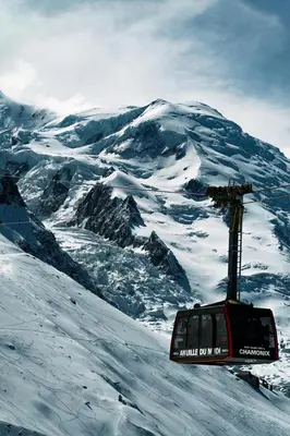 a ski lift on top of a snow covered mountain at Chalet Benoit - Modern Chalet 8 Pax Free Parking Mountain View - By Cozee Rentals in Chamonix-Mont-Blanc