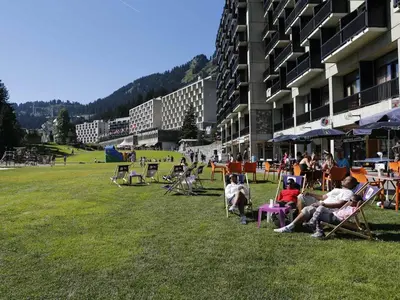 a group of people sitting in lawn chairs in a field at Studio cosy Flaine Forum, balcon sud, à deux pas des pistes, idéal 3 pers. - FR-1-687-114 in Arâches-la-Frasse