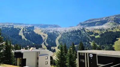 a view of the mountains from a building at Résidence Andromede - Studio agréable avec casier à ski · Proche des pistes · Balcon MAE-4274 in Magland